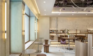 A modern cafe interior with concrete and wooden elements