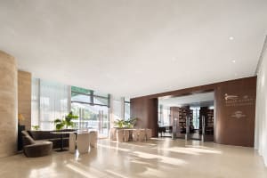 An elegant lobby with modern furniture and concrete interior design elements.