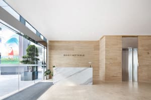 Modern office lobby featuring marble countertops and concrete walls