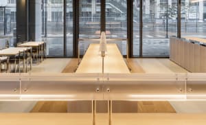 Modern restaurant interior with wooden counter and seating