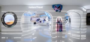 Interior of a minimalist travel agency with metallic and white design elements.