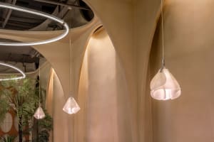 A modern interior featuring white, curved arches providing ambient lighting.