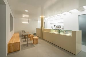 Modern cafe interior with white walls, minimalist styling, and bright lighting