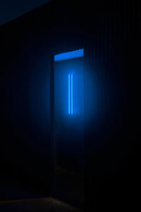Blue neon lighting in a minimalist interior space.