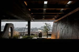 A modern industrial rooftop deck garden featuring concrete and metal elements.