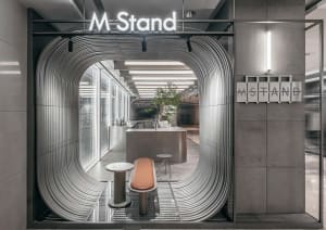 Industrial-themed cafe interior with a metal counter and seating.