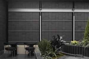 An industrial outdoor patio featuring metal furniture and plants.