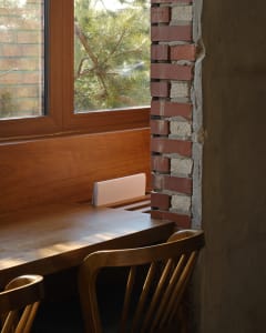 Wooden window seat with open book next to window