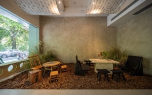Industrial-style cafe interior featuring wooden furniture and concrete walls