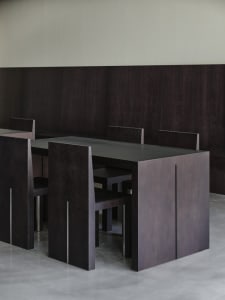 A modern dining room with dark wooden tables and chairs, modern design furniture, minimalist interior design, dark wooden flo
