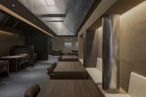 Modern interior restaurant with wooden furniture and concrete walls