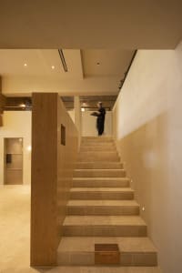 A modern stone staircase illuminated by ambient lighting within an elegant interior design setting.