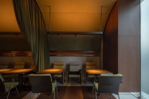 A modern industrial restaurant with wooden furniture and curtain lighting