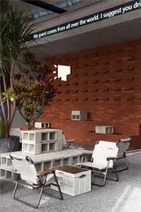 A modern industrial cafe lounge featuring concrete blocks and brick walls
