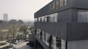 Modern building exterior with gray granite facade and glass windows