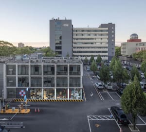 A modern office building with concrete and glass materials.