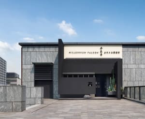 A minimalist restaurant exterior featuring a glass facade and modern design.