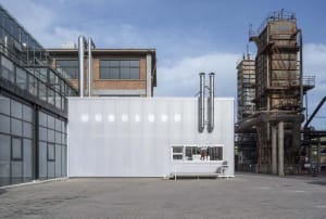Modern minimalist coffee shop with metallic exterior and white signage