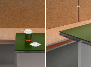 Industrial-style coffee shop counter with green top, paper coffee cup, and receipt on top.