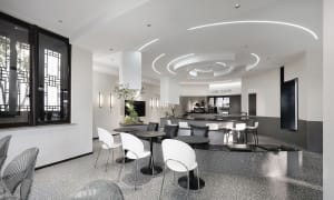 Modern interior design of a coffee shop featuring concrete and glass materials.