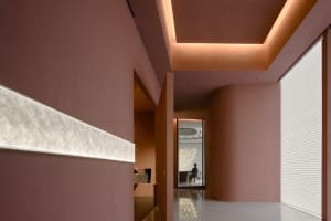 Minimalist interior design featuring a corridor with modern lighting and materials.