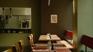 A modern restaurant interior with wooden tables and chairs