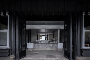 A minimalist coffee shop interior with a concrete counter.