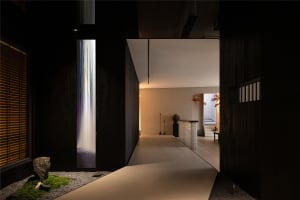 Modern minimalist hotel corridor with wooden floors and minimalist design elements.