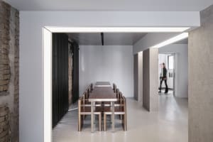 Industrial-style dining area with concrete, metal, and wooden furniture and flooring