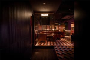Industrial-style restaurant interior with metal ceiling and modern seating areas