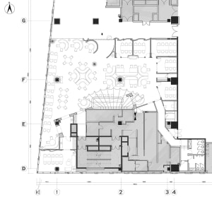 Floor plan of a modern office with desks arranged in various layouts.