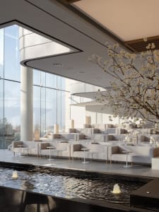 Modern minimalist lobby space with white marble floors, white sofas, and a fountain with cherry blossom branches.