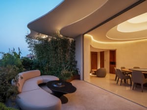 Modern residential interior featuring minimalist design with concrete and wood materials.