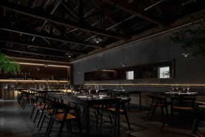 A dark, industrial-style restaurant with black steel chairs, concrete flooring, and wooden elements.
