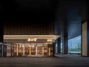 A modern retail storefront with a metallic frame and glass panels.