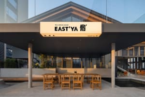 A minimalist restaurant exterior with concrete and glass materials.