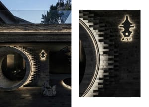 Modern interior with brick walls and circular arches illuminated by LED lighting.