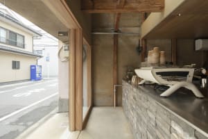 A minimalist storefront with a stone counter and coffee machine.