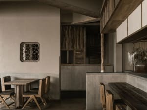 Industrial-style restaurant interior with wooden furniture and concrete walls