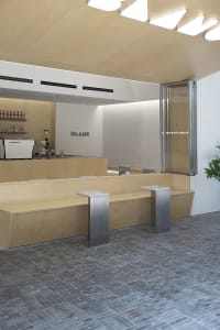 A modern coffee shop interior featuring wooden elements.