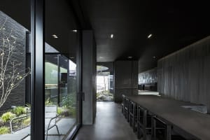 Modern commercial interior featuring minimalist design with concrete and glass materials.