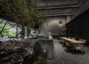 Industrial-style cafe interior with concrete features, showcasing modern design with a rustic touch.