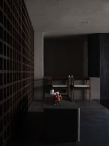 A minimalist restaurant interior with concrete and wooden elements