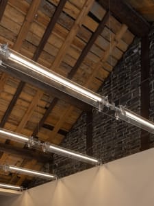 Exposed wooden beams and trusses in an industrial-style ceiling