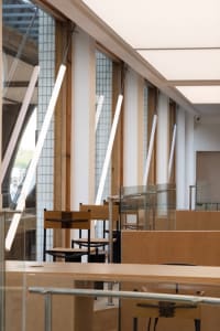 A modern industrial restaurant with wooden walls and white pillars.