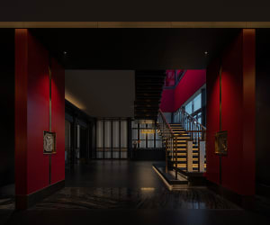 A modern hotel entryway featuring metallic and glass elements.