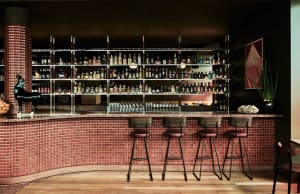 Industrial-themed bar interior with tile and concrete finishes