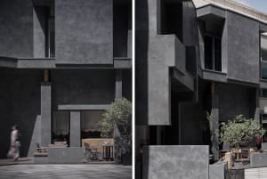 Concrete restaurant exterior with outdoor seating and greenery.