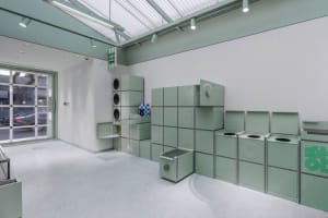 A minimalist storefront featuring green paneling.