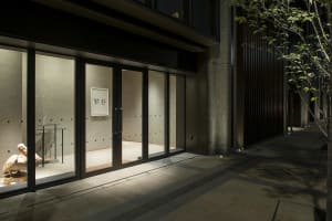 Modern retail storefront with glass doors and interior lighting.